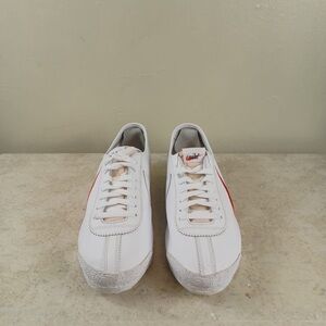 Nike White Sneakers with Red Swoosh and Blue Outsole Trim